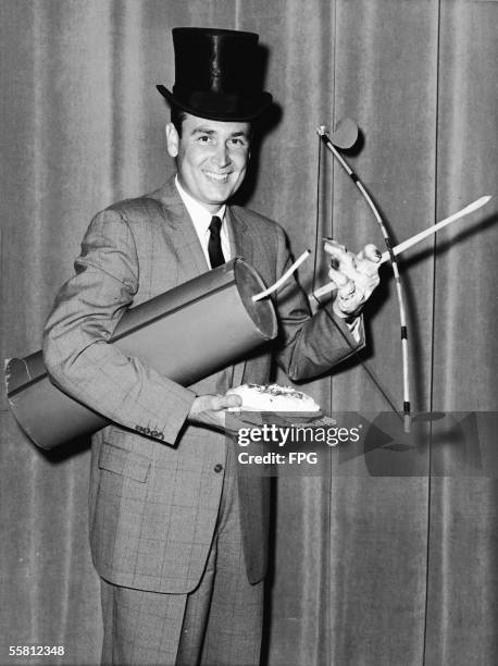 Publicity portrait of American radio and television show host Bob Barker as he poses with a number of props in preparation for hosting the television...