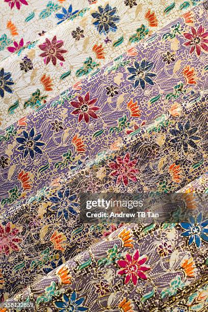 rows of batik fabric - malaysia batik stock pictures, royalty-free photos & images
