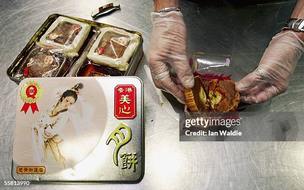 Quarantine inspection officer seizes moon cakes made from avian products from a passenger's baggage at Sydney International Airport September 28,...