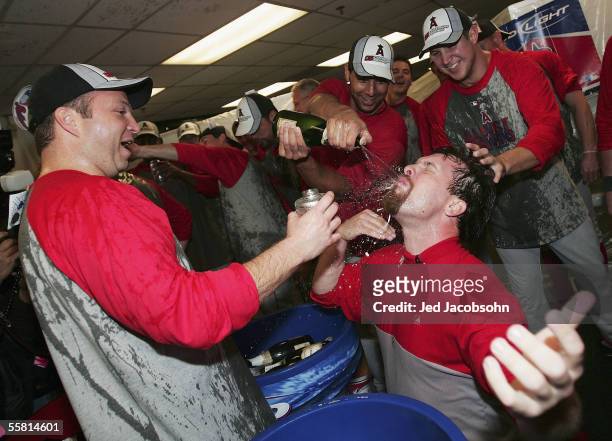 Josh Paul and Tom Taylor of the Los Angeles Angels of Anaheim celebrate after beating the Oakland Athletics and clinching the American League West...