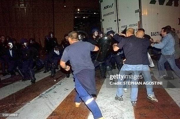 Workers protesting the sale of their debt-ridden National Corsica Mediterranean Company to a French investment group, clash with police forces, early...