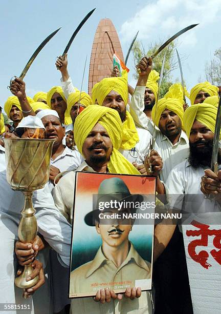 Activists from the All India Anti -Terrorist Front shout slogans as they celebrate the birth anniversary of Indian freedom fighter Bhagat Singh at...