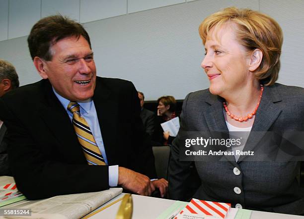 Michael Glos, Christian Democratic Union General Secretary, and Angela Merkel, CDU party leader, arrive to their party's meeting in the Reichstag on...