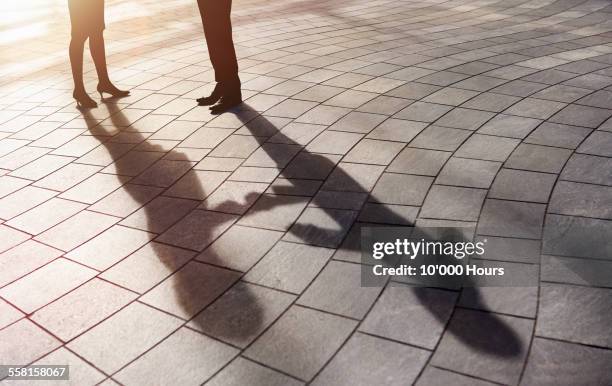 shadow of business people shaking hands - dela ut kort bildbanksfoton och bilder