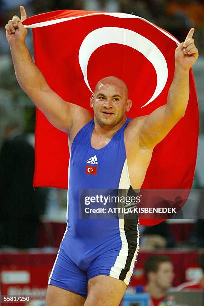 Turkish Aydan Polatci celebrates his gold medal with his national flag, after beating Alexis Rodriguez of Cuba in 'Laszlo Papp' Sport Arena of...