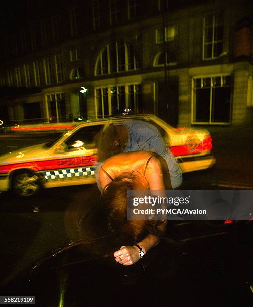 Police car pulling up to deal with a drunk couple on the streets of Newcastle, 1999.