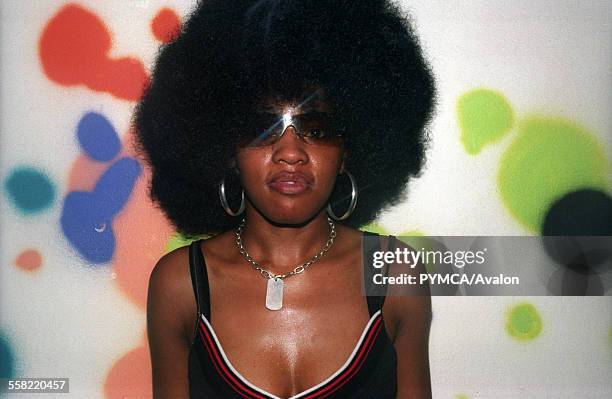 Woman with a massive afro wearing sunglasses at the Tribal Gathering Warehouse Party, Manchester, UK, August 2003.