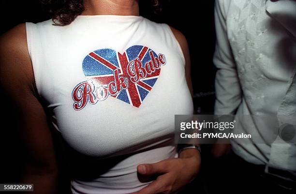Woman wearing a Rock Babe Union Jack t-shirt in a bar in Shoreditch, East London, UK, 2000s.