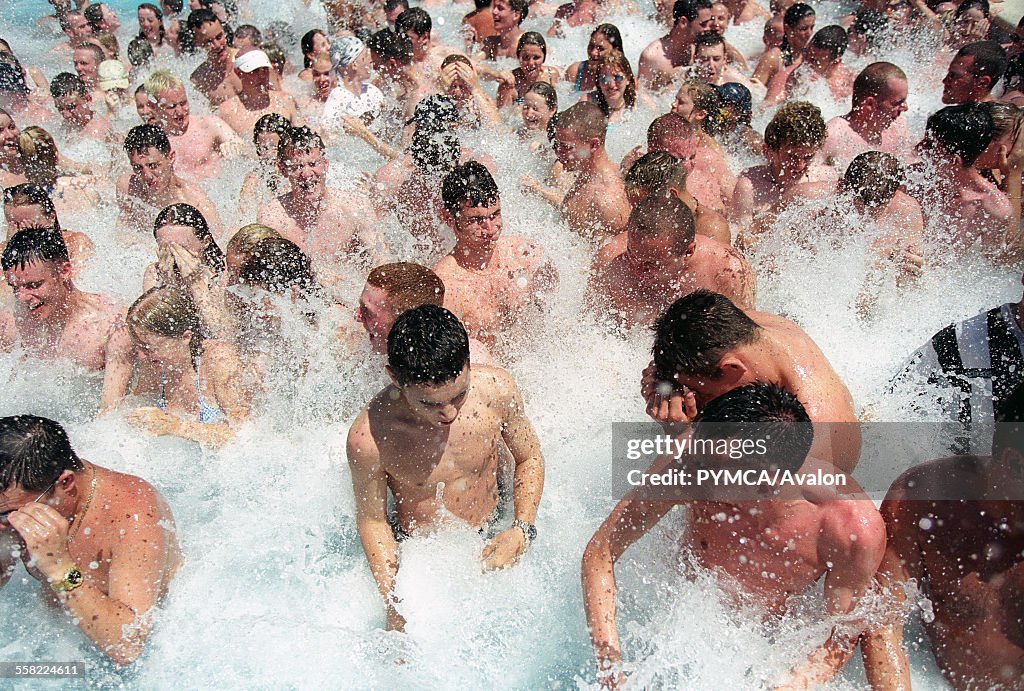 Brits abroad, young English people at a pool party, splashing water, Club 18-30 Ibiza, 2001