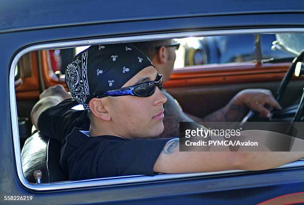 Young attractive man witha bandana and sunglasses riding in a Hotrod car, Viva Las Vegas Festival, Las Vegas, USA 2006..