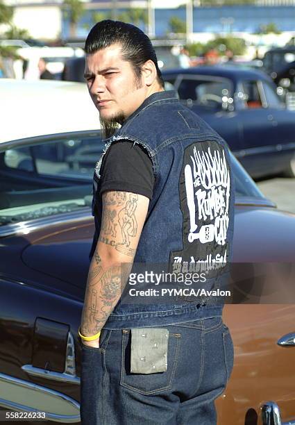 Rockabilly boy in front of a Hotrod, looking backwards, Viva Las Vegas Festival, Las Vegas, USA 2006..