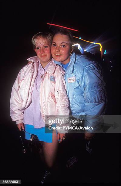 Teenage girls at an under 18s club pose in matching Schott bomber jackets with the velcro badges swapped , 20/11/99.