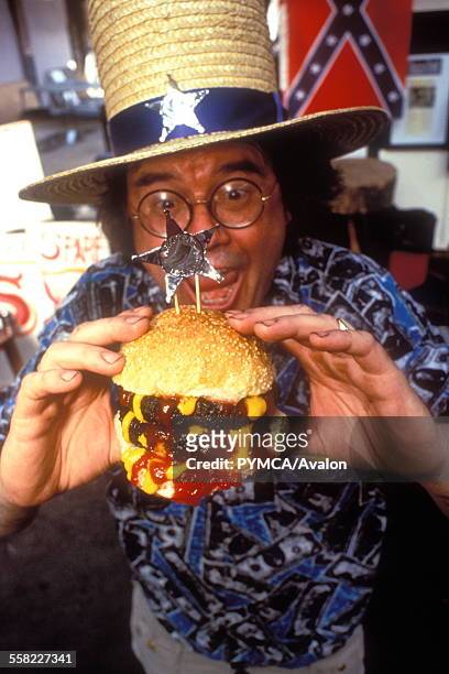 Fast Food, a man eating a double burger.