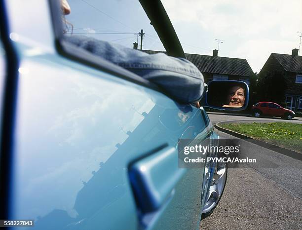 Girl racers with their cars, UK, 2000s.