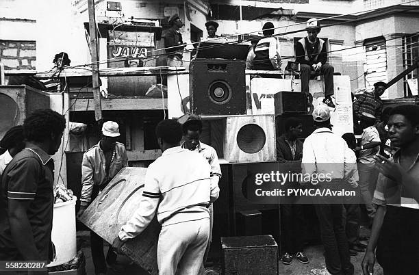 Group of people moving speakers, constructing a sound system Notting Hill, Carnival, London, UK, 1983.