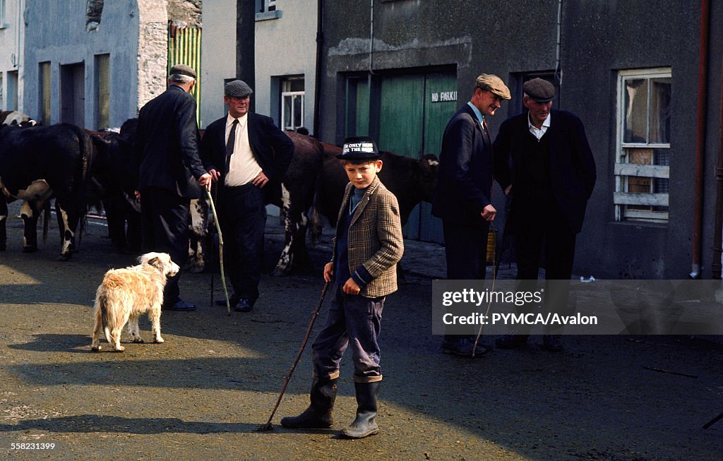 Group of farmers standing in the street, Puck Fair, Killorglin, Ireland, 1973