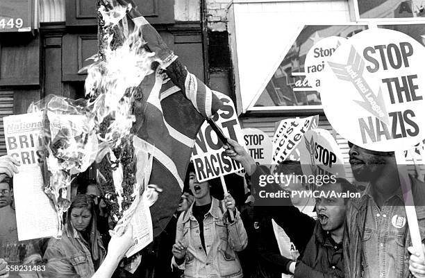 Anti-racists and Leftists burn a Union Jack flag after fighting fascists in Brick Lane, East London, .