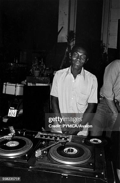 Smiling DJ standing in front of his decks during street party held for Charles and Di's wedding Fulham London 1981.