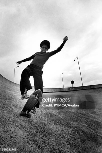 Boy skateboarding on a roundabout Wandsworth London UK 1977.