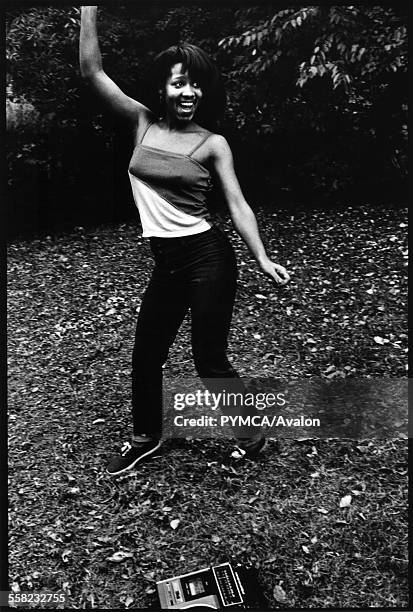 Woman dancing next to her boom box in Central Park New York, USA, 1980.