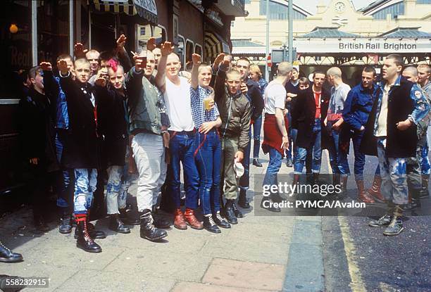 Gang of skinheads giving the salute outside the pub, Brighton, UK 1980's.