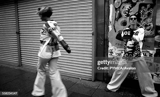 Manchester kids in Joe Bloggs flares and baggy tops skip down the street, Manchester 1988.