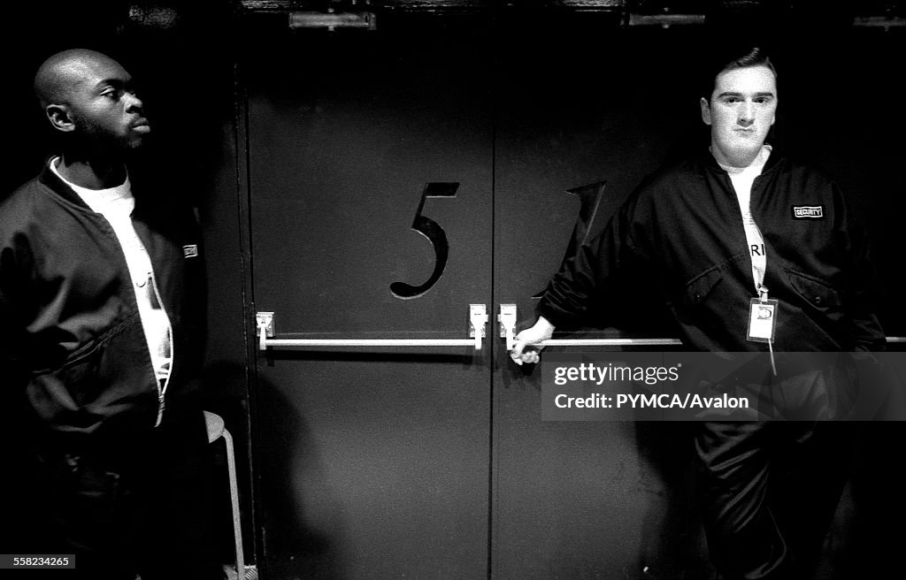 Two members of security stand by the main Fac 51 doors to the Hacienda, Manchester, early 1990's
