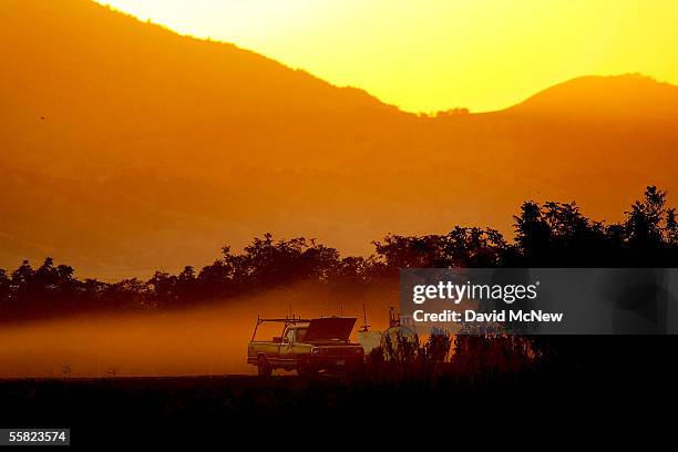 The sun sets behind a farm next to the community of Discovery Bay, one of the residential islands surrounded by levees that hold back higher the...