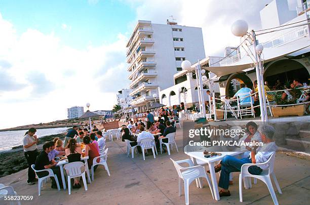 People enjoying daytime drinks at Cafe Del Mar, San Antonio, Ibiza, 1990s.