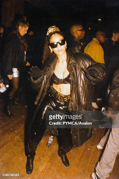 Woman on dancefloor wearing bulky leather coat at Voodoo Magic, The Empire, London, 1995.