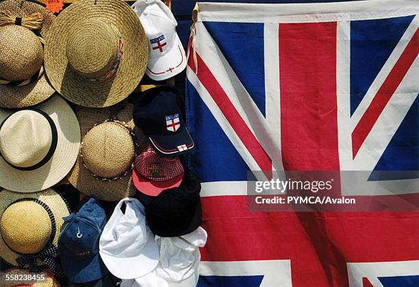 Selection of hats next to a Union Jack flag.
