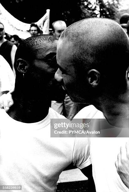 Two black men kissing at a Gay Pride parede in London, circa 1995.