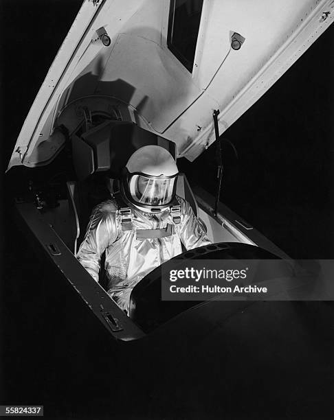 The pilot of a North American X-15 rocket plane climbs into the cockpit, circa 1960. X-15 pilots were awarded astronaut status by the USAF, since the...