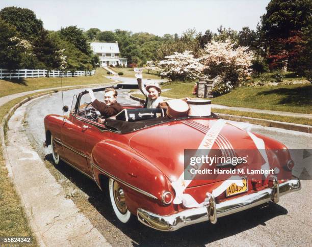 Two newly-weds embark on their life together in a red Pontiac convertible, 1949.