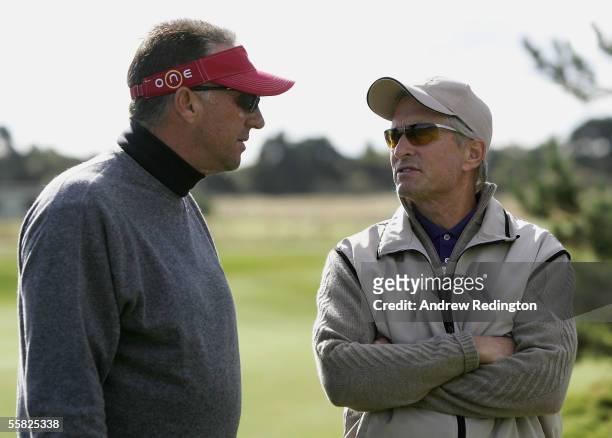 Former England cricketer Ian Botham talks with actor Michael Douglas during the first round of the Dunhill Links Championships at the Carnoustie Golf...