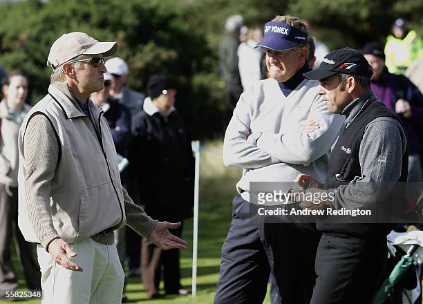 Actor Michael Douglas talks with Colin Montgomerie of Scotland and Paul McGinley of Ireland during the first round of the Dunhill Links Championships...