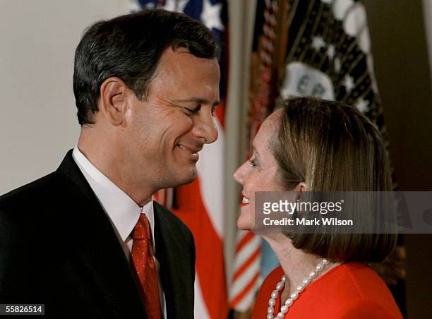 Chief Justice of the United States Supreme Court John Roberts hugs his wife Jane Roberts after being sworn during a ceremony in the East Room at the...