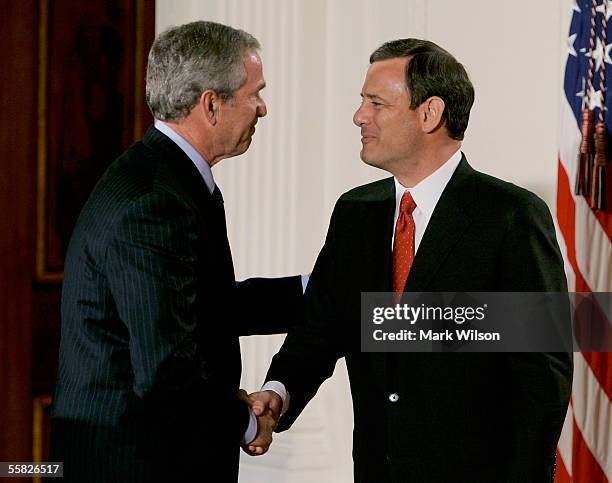 President George W. Bush congratulates Chief Justice of the United States Supreme Court John Roberts after being sworn during a ceremony in the East...