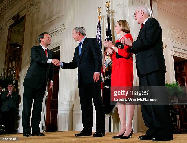 President George W. Bush congratulates Chief Justice of the United States Supreme Court John Roberts after being sworn in as Associate Justice John...