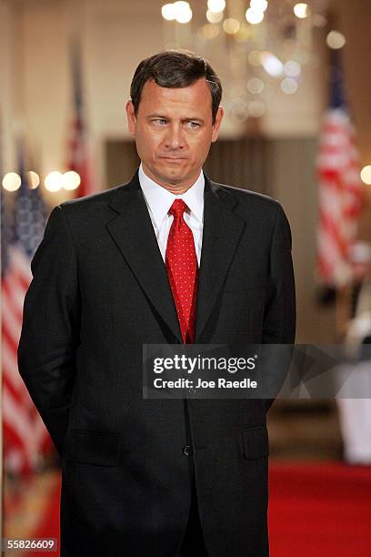 John Roberts listens as U.S. President George W. Bush introduces him as the new Chief Justice of the U.S. During a swearing in ceremony in the East...