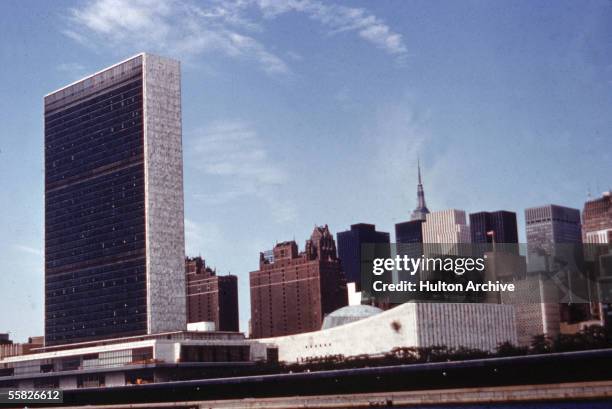 Exterior view of the United Nations Headquarters building and surrounding midtown area as seen looking West from the East River, New York, New York,...