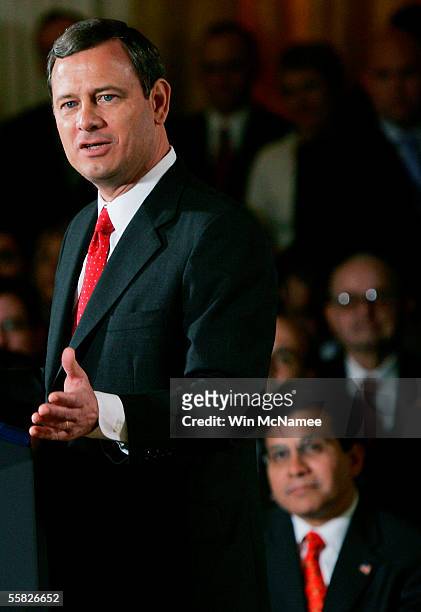 Supreme Court Chief Justice John Roberts speaks after being sworn in as U.S. Attorney General Alberto Gonzalez looks on in the East Room of the White...