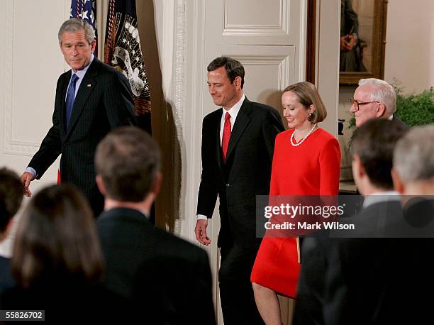 President George W. Bush walks in the East Room with John Roberts , his wife Jane Roberts and Associate Justice John Paul Stevens during the swearing...