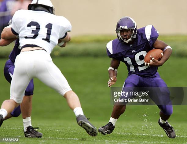Running Back Tyrell Sutton of the Northwestern Wildcats runs with the ball against linebacker Paul Posluszny of the Penn State Nittany Lions...