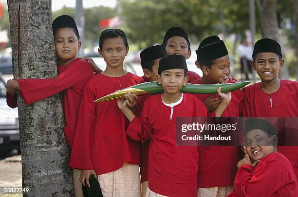 Young boys dressed in 'Baju Melayu' welcome the arrival of the Melbourne 2006 Queen's Baton September 30, 2005 in Kuala Muda, Malaysia. The Baton...