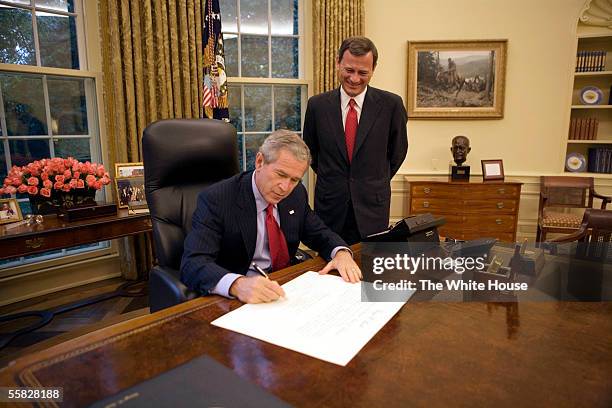 In this handout photo provided by the White House, President George W. Bush signs the commission appointing John Roberts as the 17th Chief Justice of...