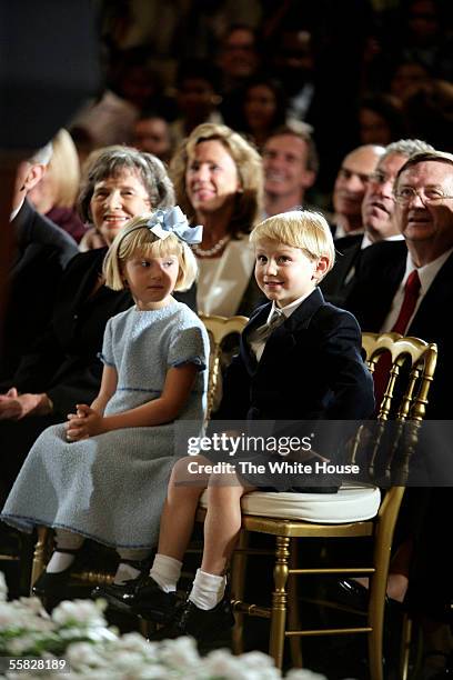 In this handout photo provided by the White House, Jack and Josie Roberts look on as their father, John G. Roberts Jr., takes the Oath of Office as...
