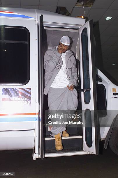 Guard Allen Iverson of the Philadelphia 76ers talks on his cell phone as he leaves the team bus before the NBA game against the Memphis Grizzlies at...