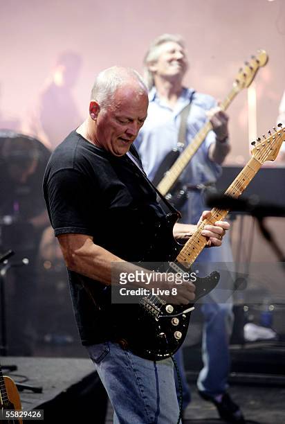 Dave Gilmour of Pink Floyd and Roger Waters perform on stage at "Live 8 London" in Hyde Park on July 2, 2005 in London, England. The free concert is...