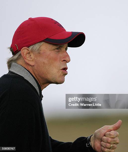 Actor Michael Douglas reacts to his second shot at the 17th hole during the second round of the Dunhill Links Championships on the Old Course,...